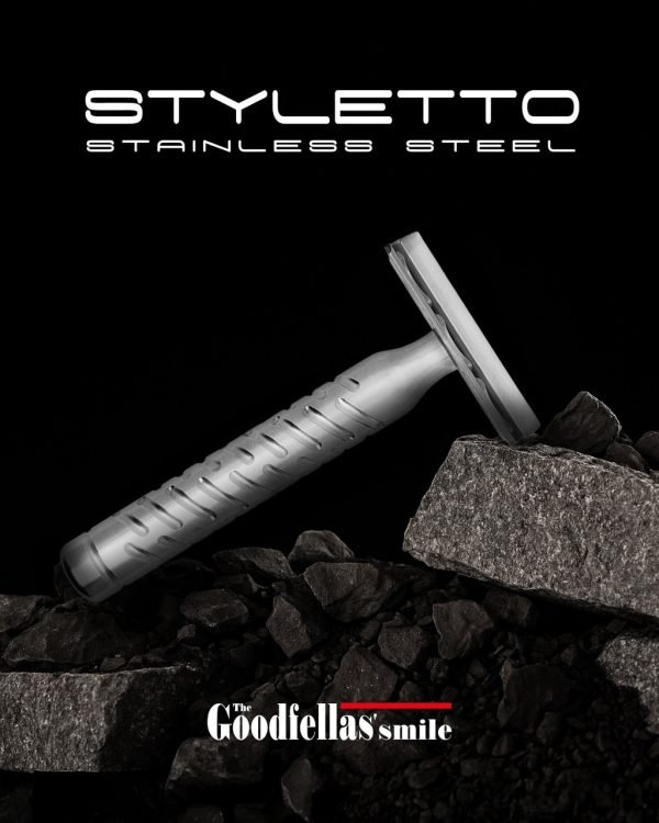 The Goodfellas’ Smile Styletto V2 stainless steel safety razor lifestyle photo on rocks, black background
