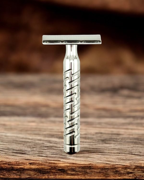 The Goodfellas’ Smile Styletto V2 stainless steel safety razor standing on wood surface, lifestyle shot