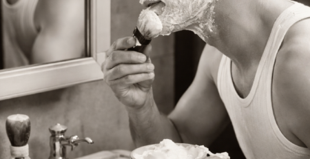 Perfect shaving lather being applied with a brush beside a double edge safety razor