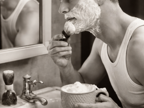Perfect shaving lather being applied with a brush beside a double edge safety razor
