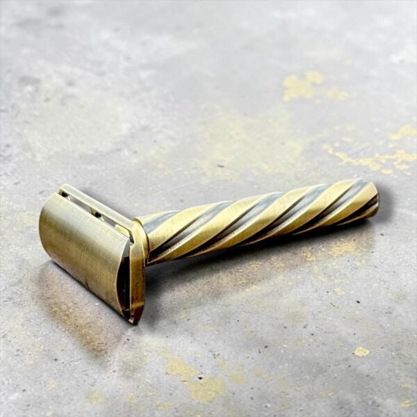 Parker Flight brass safety razor lying at an angle showing the antique brass finish