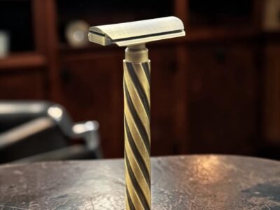 Parker Flight brass safety razor standing upright showing the spiral-pattern grip