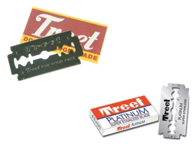 Treet Black Beauties carbon steel razor blade pack and blade beside a Treet Platinum Super Stainless pack and blade on a white background