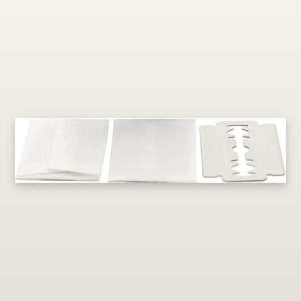 Loose KAI Stainless double edge razor blades in individual paper wrappers with one unwrapped blade, sold by the blade