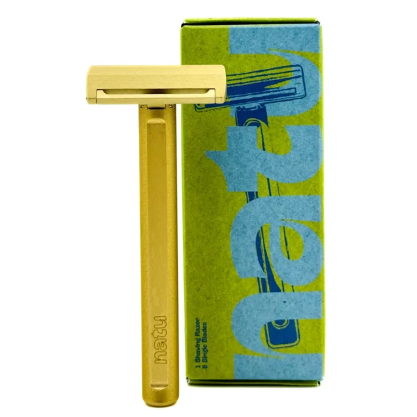 NATU single edge pivot head safety razor with a gold anodised aluminium handle, shown with its retail box