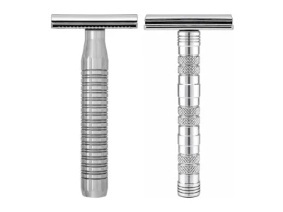 The Goodfellas' Smile Lybra solid 316L stainless safety razor beside the chrome plated brass Dominus razor on a white background