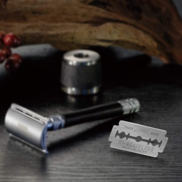 Feather Black double edge blade beside a safety razor
