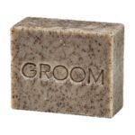 GROOM North Soap bar, grey-blue with dark flecks, embossed with the GROOM name, on a white background