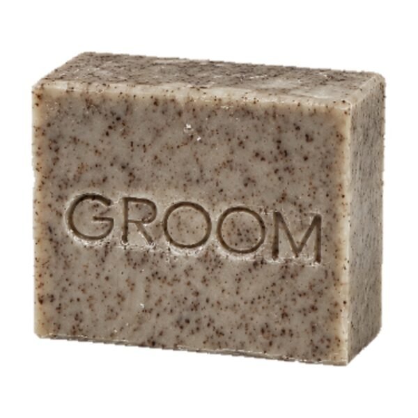 GROOM North Soap bar, grey-blue with dark flecks, embossed with the GROOM name, on a white background